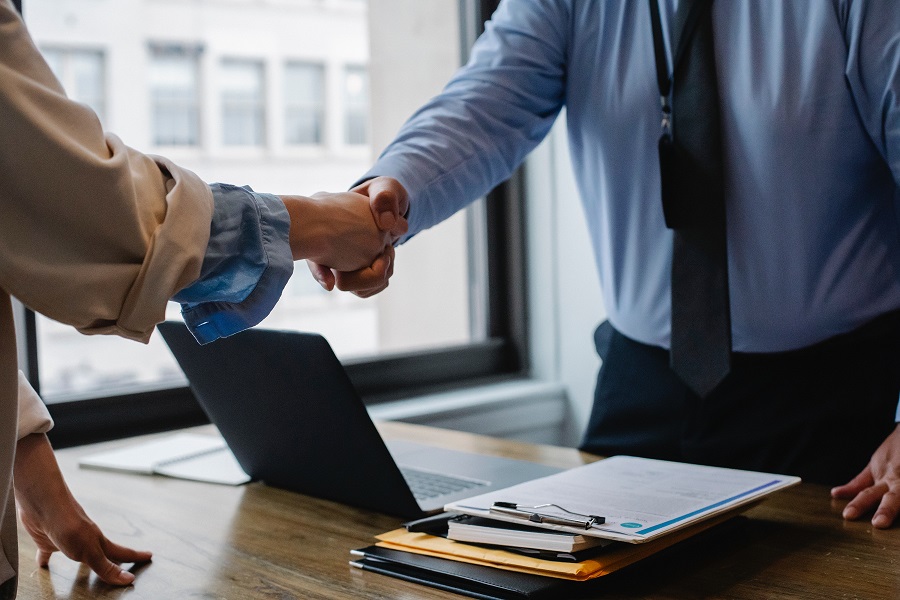 Financial records, account statements, and analysis spread across an investigator's desk